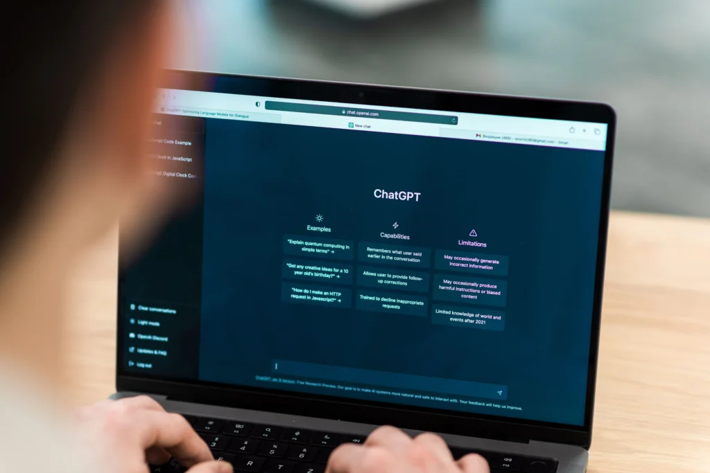 Person using ChatGPT on a laptop, symbolizing the innovation and expertise offered by top Generative AI Development Companies for enterprise Node.js projects.
