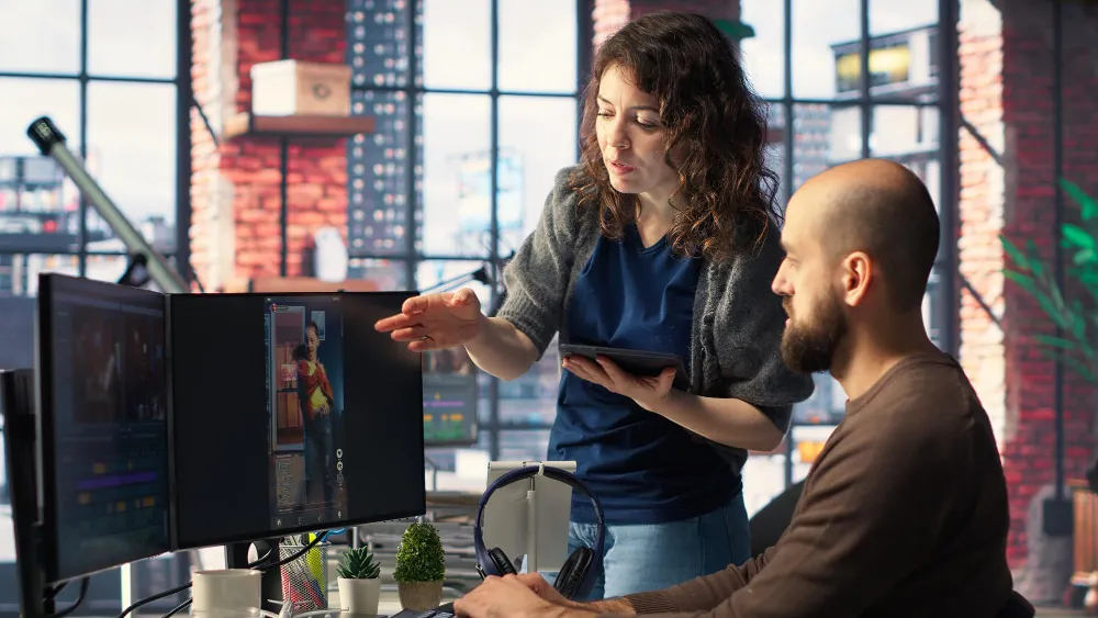 DevOps specialists collaborating on deployment dashboards and CI/CD workflows, illustrating how Managed DevOps Services support modern enterprises with automation, scalability, and continuous delivery.