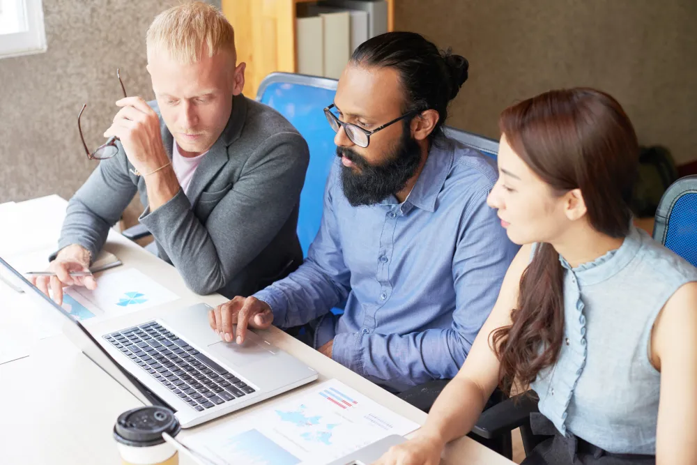 Team planning and analyzing Budget React.js Development while reviewing project costs, performance metrics, and AI-ready application strategies.