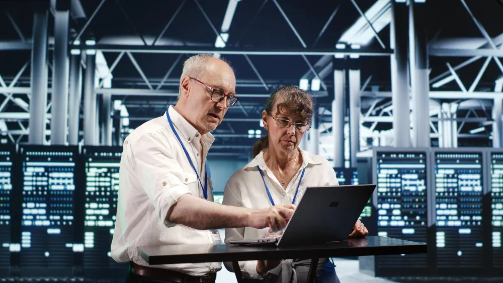IT leaders discussing Platform Engineering vs DevOps strategies while reviewing cloud infrastructure dashboards and deployment automation tools.