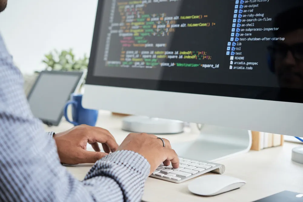 Developer working on code illustrating GitOps vs DevOps workflows with automation pipelines and version control systems
