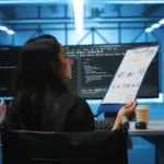 Engineer analyzing DevOps as a Service Architecture dashboards with automated workflows, CI/CD pipelines, and cloud infrastructure tools