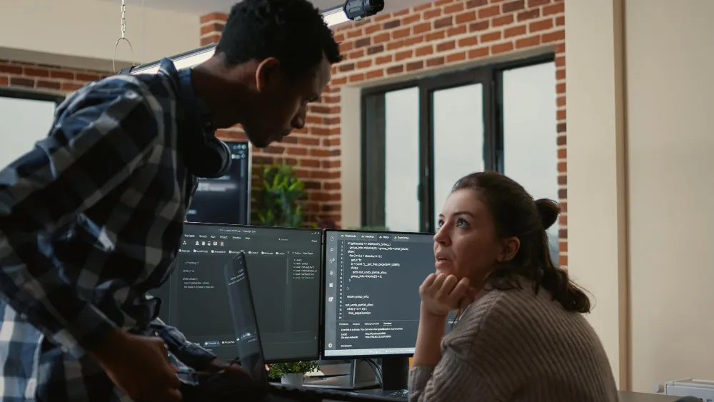 Development team discussing DevOps as a Service for Enterprises vs Startups and evaluating workflows, automation, and scalability requirements